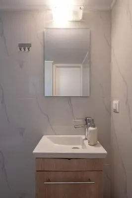 a bathroom with a sink and a mirror at “Athens Cosmos” Apartment in Neos Kosmos in Athens