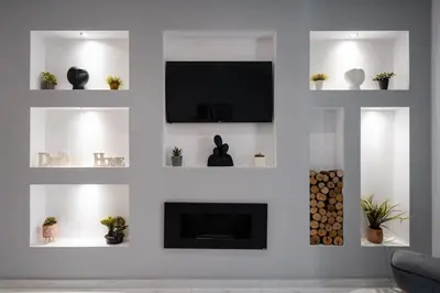a living room with white walls and a fireplace at “Athens Cosmos” Apartment in Neos Kosmos in Athens