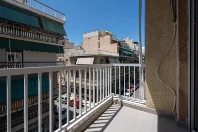 a balcony of a building with a view of a street at “Athens Cosmos” Apartment in Neos Kosmos in Athens