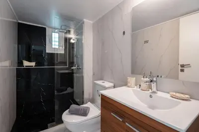 a bathroom with a toilet and a sink and a shower at “Athens Cosmos” Apartment in Neos Kosmos in Athens