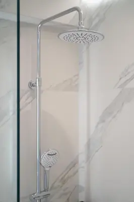 a shower with a shower head in a bathroom at Acropolis Luxury Penthouses with Majestic Views in Athens