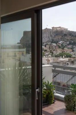 a view of a city from a window at Acropolis Luxury Penthouses with Majestic Views in Athens