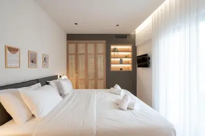 a bedroom with a large white bed with white pillows at Acropolis Luxury Penthouses with Majestic Views in Athens
