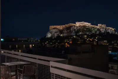 a view of the acropolis from a balcony at night at Acropolis Luxury Penthouses with Majestic Views in Athens