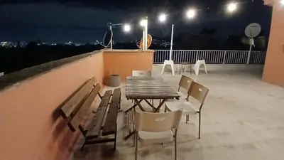 a table and chairs on a balcony at night at Eagle's Nest Acropolis View in Athens