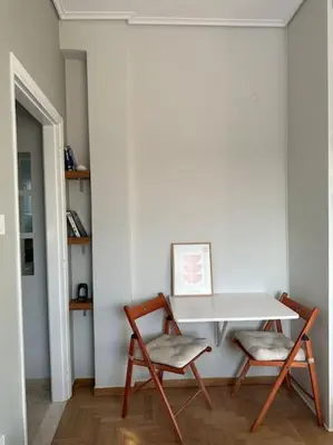 a white table and two chairs in a room at Eagle's Nest Acropolis View in Athens