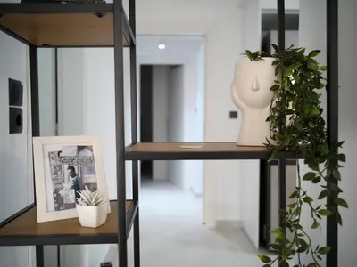 a room with two shelves with plants and a vase at ILIADA Luxury Apartment in Porto Rafti