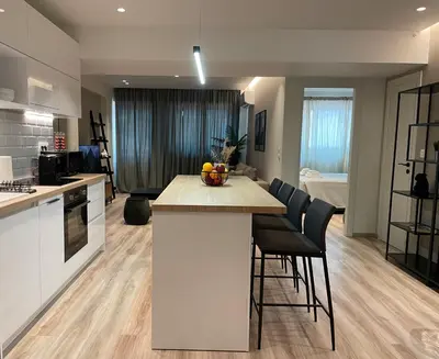 a kitchen and living room with a island in a room at Modern & Spacious 3BR apartment in Athens