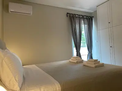 a bedroom with a bed with two towels on it at Modern & Spacious 3BR apartment in Athens