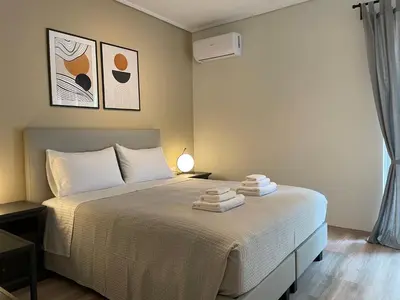 a bedroom with a bed with towels on it at Modern & Spacious 3BR apartment in Athens
