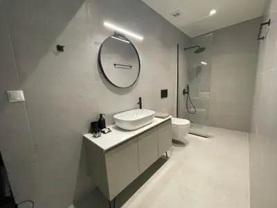 a bathroom with a sink and a toilet and a mirror at Modern & Spacious 3BR apartment in Athens