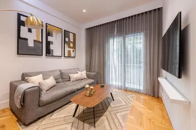 a living room with a couch and a table at Phaedrus Living: Executive Flat Kolonaki in Athens