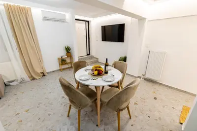 a dining room with a white table and chairs at Lux Residence Near Acropolis VIPGreece in Athens