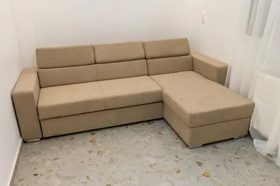 a brown couch sitting in a living room at Lux Residence Near Acropolis VIPGreece in Athens