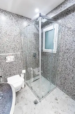 a bathroom with a glass shower with a toilet at Lux Residence Near Acropolis VIPGreece in Athens