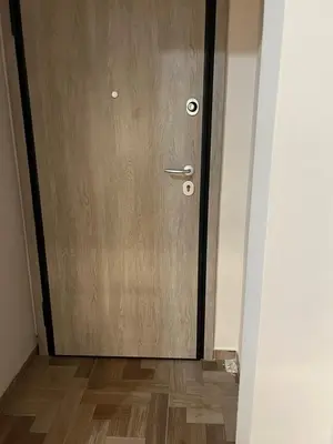 a wooden door in a room with a wooden floor at Evita's cozy apartment in Athens