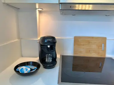 a coffee maker sitting on a counter next to a box at Central Glyfada 2BR Apartment in Athens