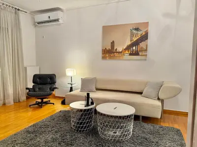 a living room with a couch and a chair at Central Glyfada 2BR Apartment in Athens