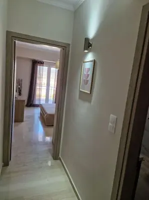 a hallway with a door leading to a living room at Casa al Mare Anavissos in Anavissos