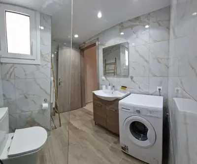 a bathroom with a washing machine and a washer at Casa al Mare Anavissos in Anavissos