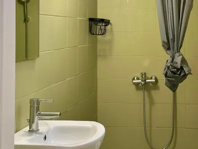a bathroom with a sink and a shower stall at Heart of Athens thiseio (2) in Athens
