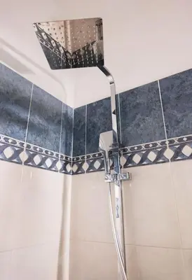 a shower with a shower head in a bathroom at Bravo 2 City Center Room in Athens