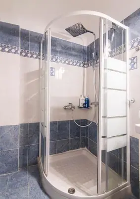 a shower with a glass door in a bathroom at Bravo 2 City Center Room in Athens