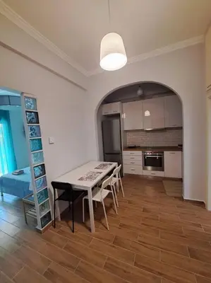 a kitchen with a table and chairs in a room at Νέο στούντιο, Νέος Κόσμος in Athens