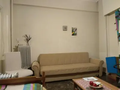 a living room with a couch and a chair at Central appartement in Athens