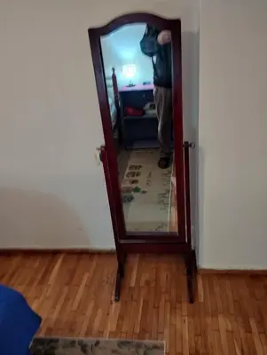 a person standing in front of a mirror at Central appartement in Athens