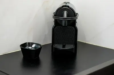 a black bottle and a cup on a counter at Central 2BR Apartment in the Heart of Athens in Athens