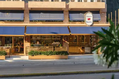 a restaurant with blue awnings in front of a building at Central 2BR Apartment in the Heart of Athens in Athens