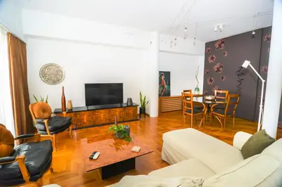 a living room with a couch and a table at Φωτεινό κομψό & άνετο διαμέρισμα κοντά στο κέντρο! in Athens
