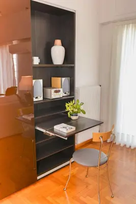 a desk with a chair in a room at Φωτεινό κομψό & άνετο διαμέρισμα κοντά στο κέντρο! in Athens
