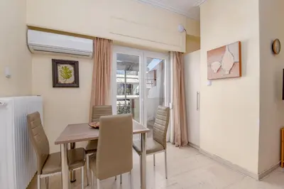 a dining room with a table and chairs at Marina Zeas Bella Vista in Piraeus