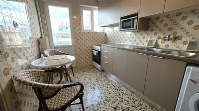 a small kitchen with a table and a sink at Marina Zeas Bella Vista in Piraeus