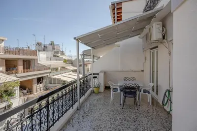 a balcony with a table and chairs on it at Marina Zeas Bella Vista in Piraeus
