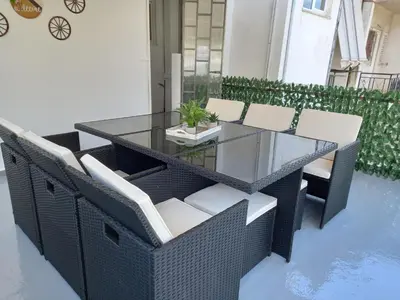 a glass table and chairs on a patio at 011eleven Apartments in Athens