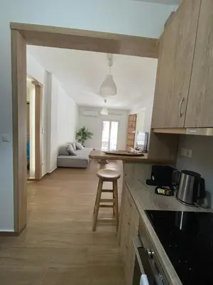 a kitchen and living room with a couch and a table at Le musée in Athens