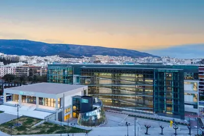 a large building in front of a city at Le musée in Athens