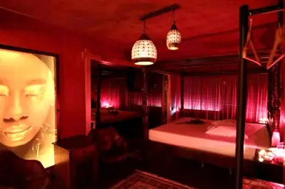a red room with a bed and a poster of a woman at The Crystal Blue Hotel in Athens