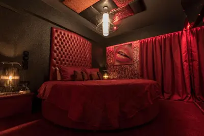 a red bedroom with a bed with a red bedspread at The Crystal Blue Hotel in Athens