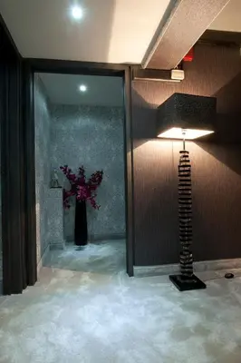 a room with a vase of flowers and a lamp at The Crystal Blue Hotel in Athens