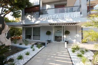 a building with a sign that reads coastal blue at The Crystal Blue Hotel in Athens