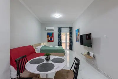 a living room with a red couch and a table at Άνετο στούντιο στο κέντρο in Athens