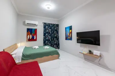 a bedroom with a bed and a flat screen tv at Άνετο στούντιο στο κέντρο in Athens