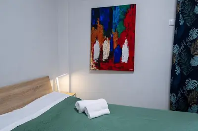 a bedroom with a bed and a painting on the wall at Άνετο στούντιο στο κέντρο in Athens