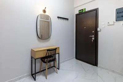 a mirror and a desk next to a door at Άνετο στούντιο στο κέντρο in Athens