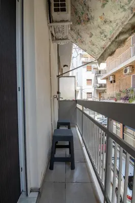 a balcony with a blue bench on the side of a building at Άνετο στούντιο στο κέντρο in Athens