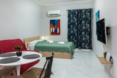 a room with two beds and a table at Άνετο στούντιο στο κέντρο in Athens